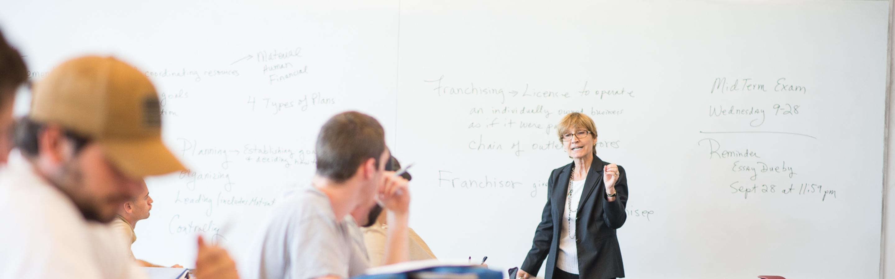 Woman teaching students