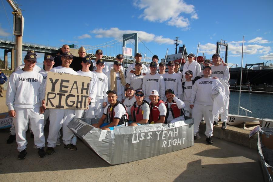 A group of Maritime students pose for a picture with their created boat for the Will it Float event.